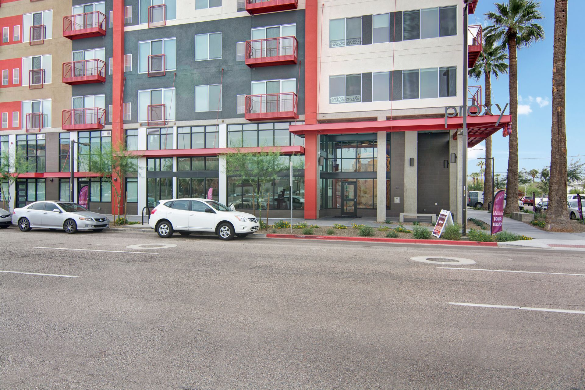 A white suv is parked in front of a building.