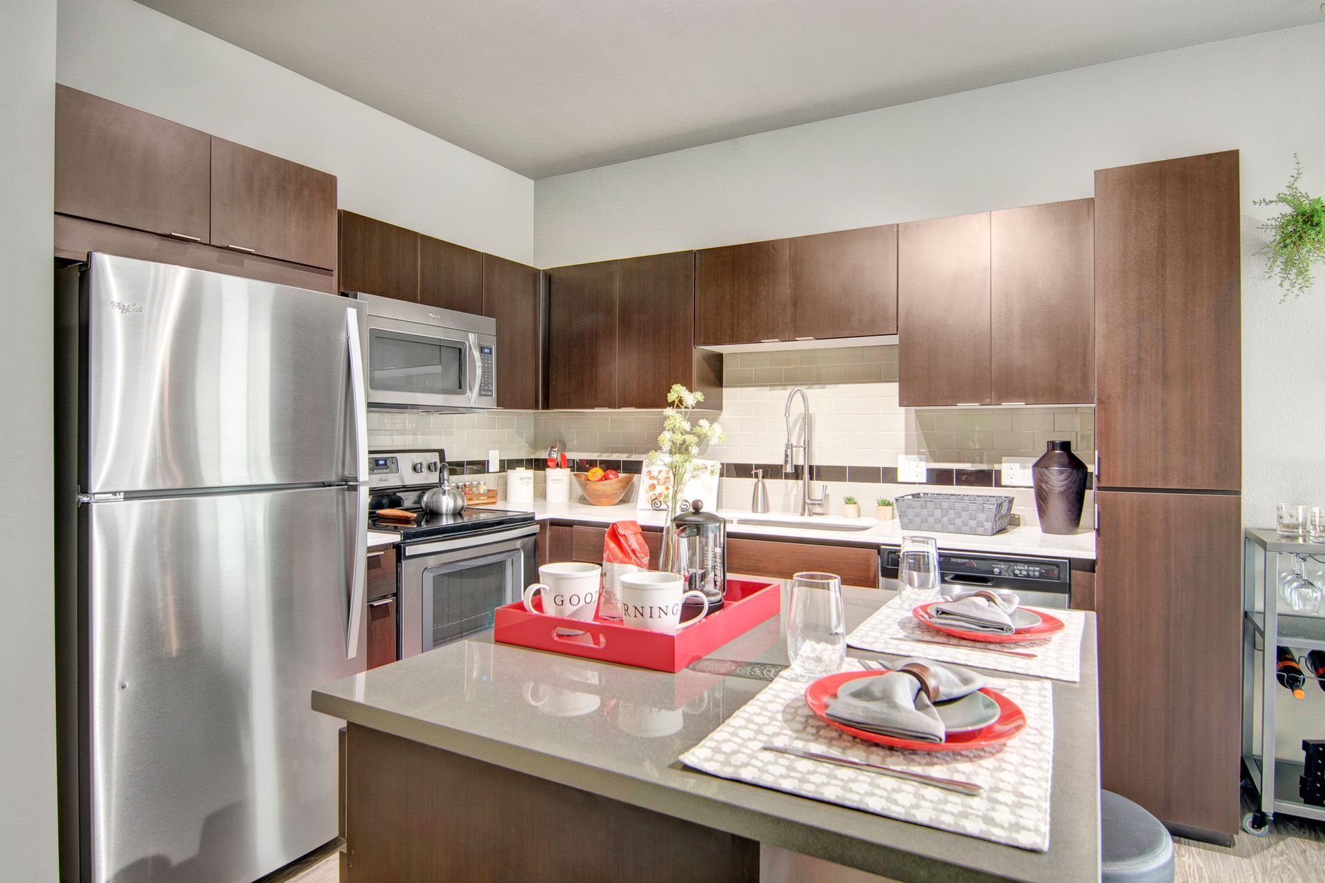 A kitchen with stainless steel appliances and a tray on the counter.
