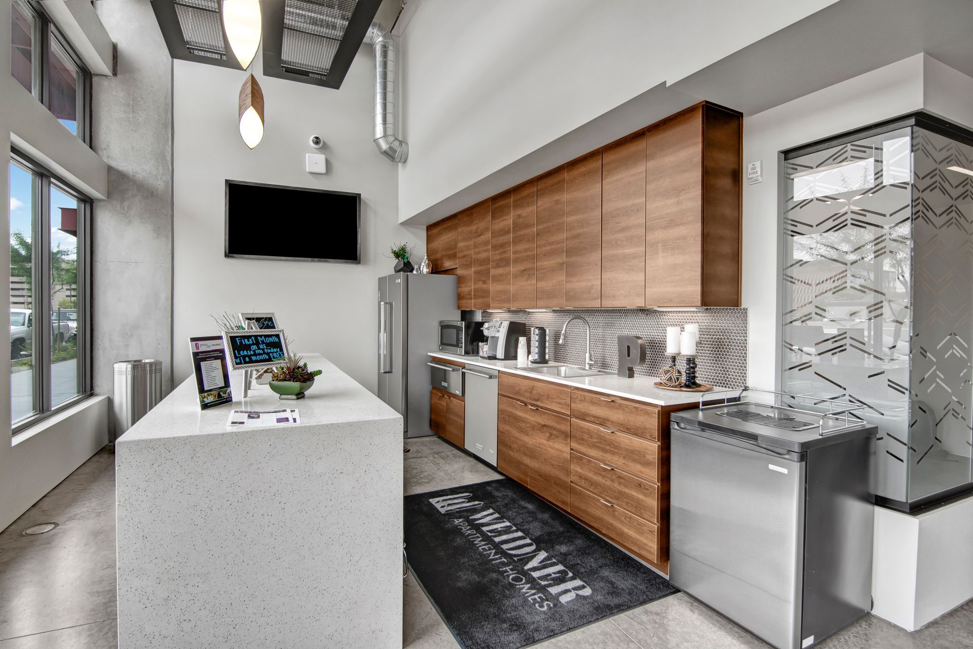 A kitchen with stainless steel appliances and wooden cabinets.