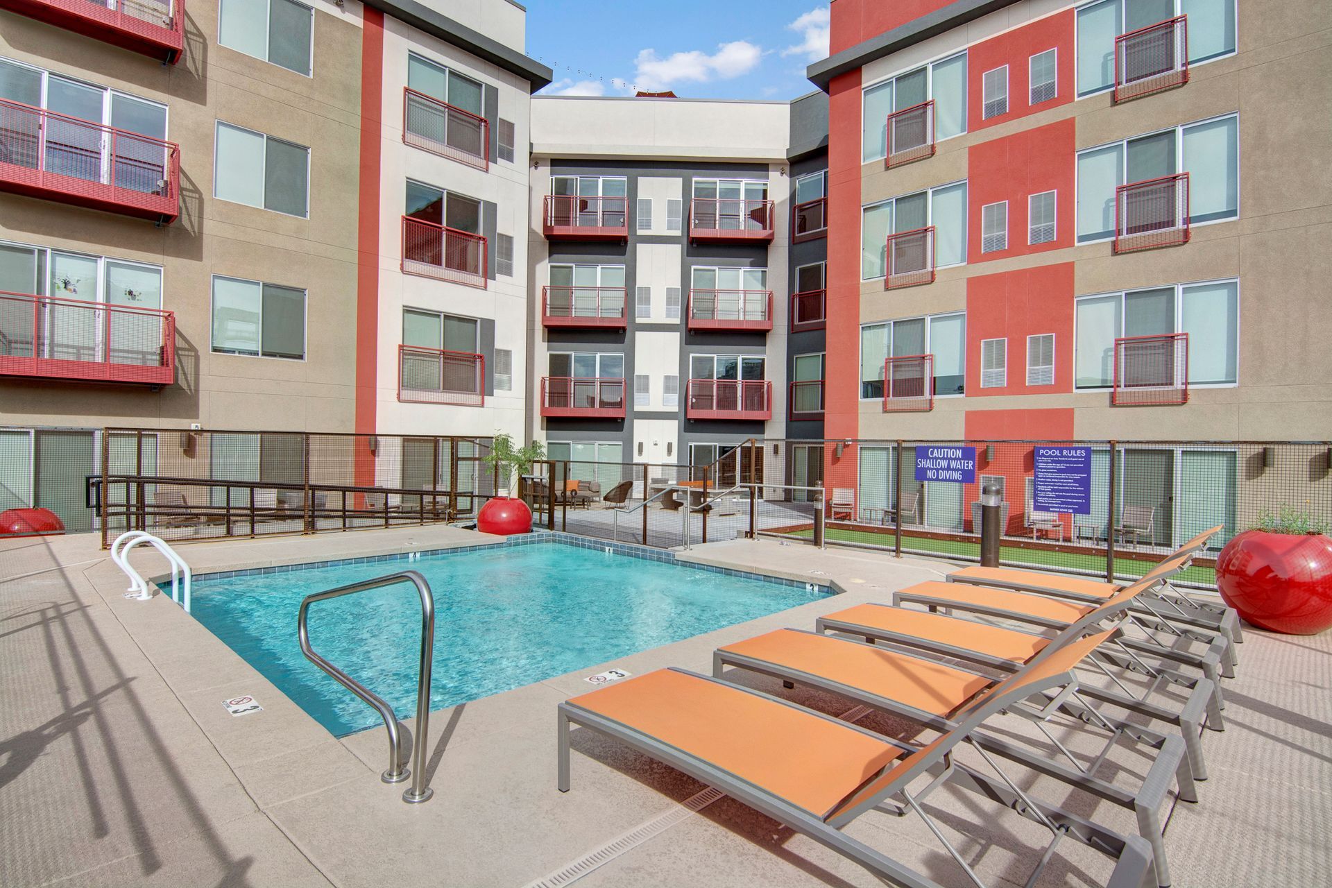 There is a large swimming pool in the middle of a building.