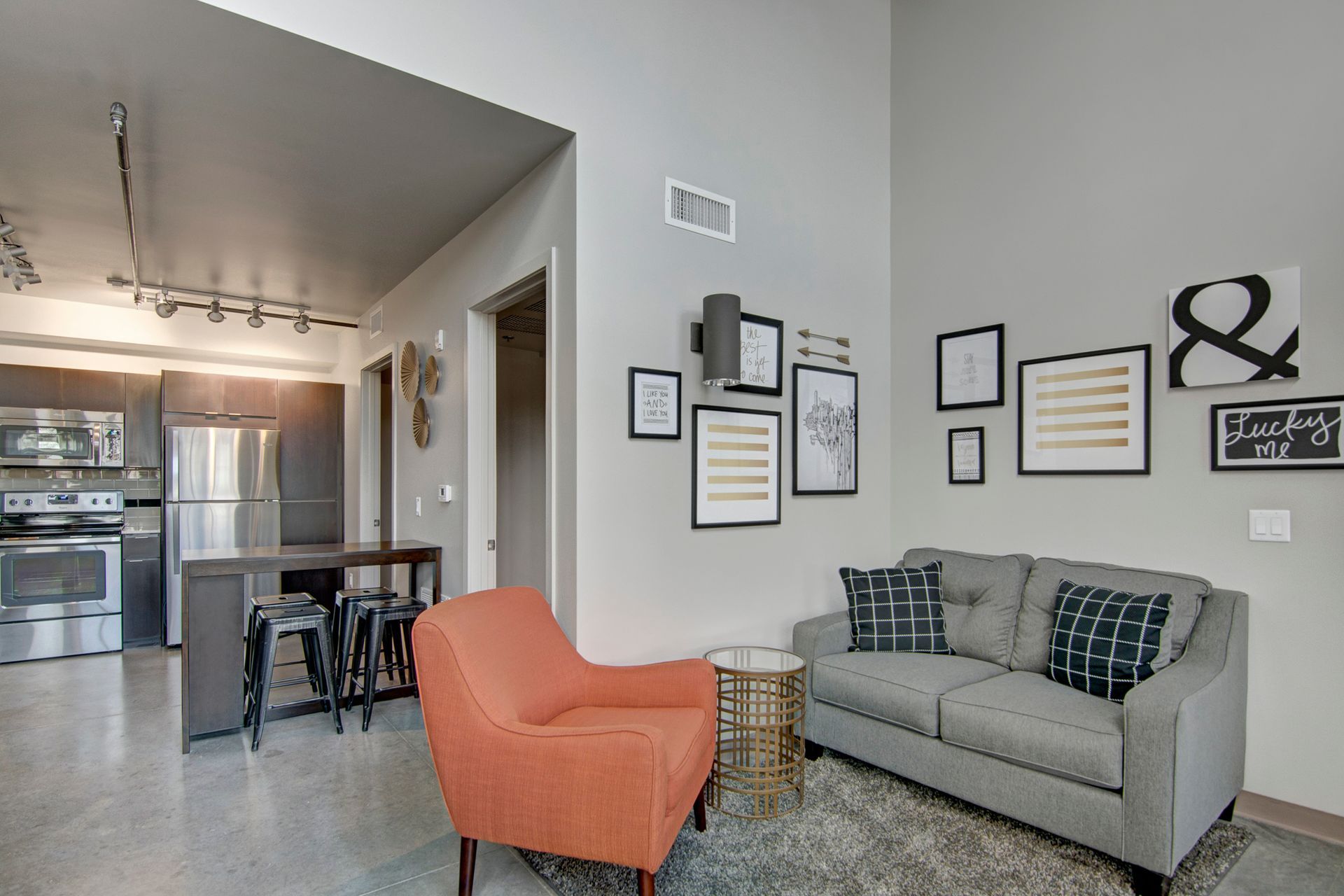 A living room with a couch , chair , and table.