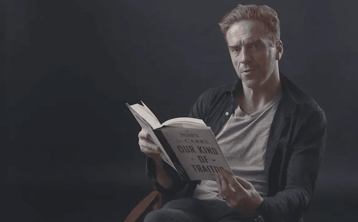 Man reading a book titled