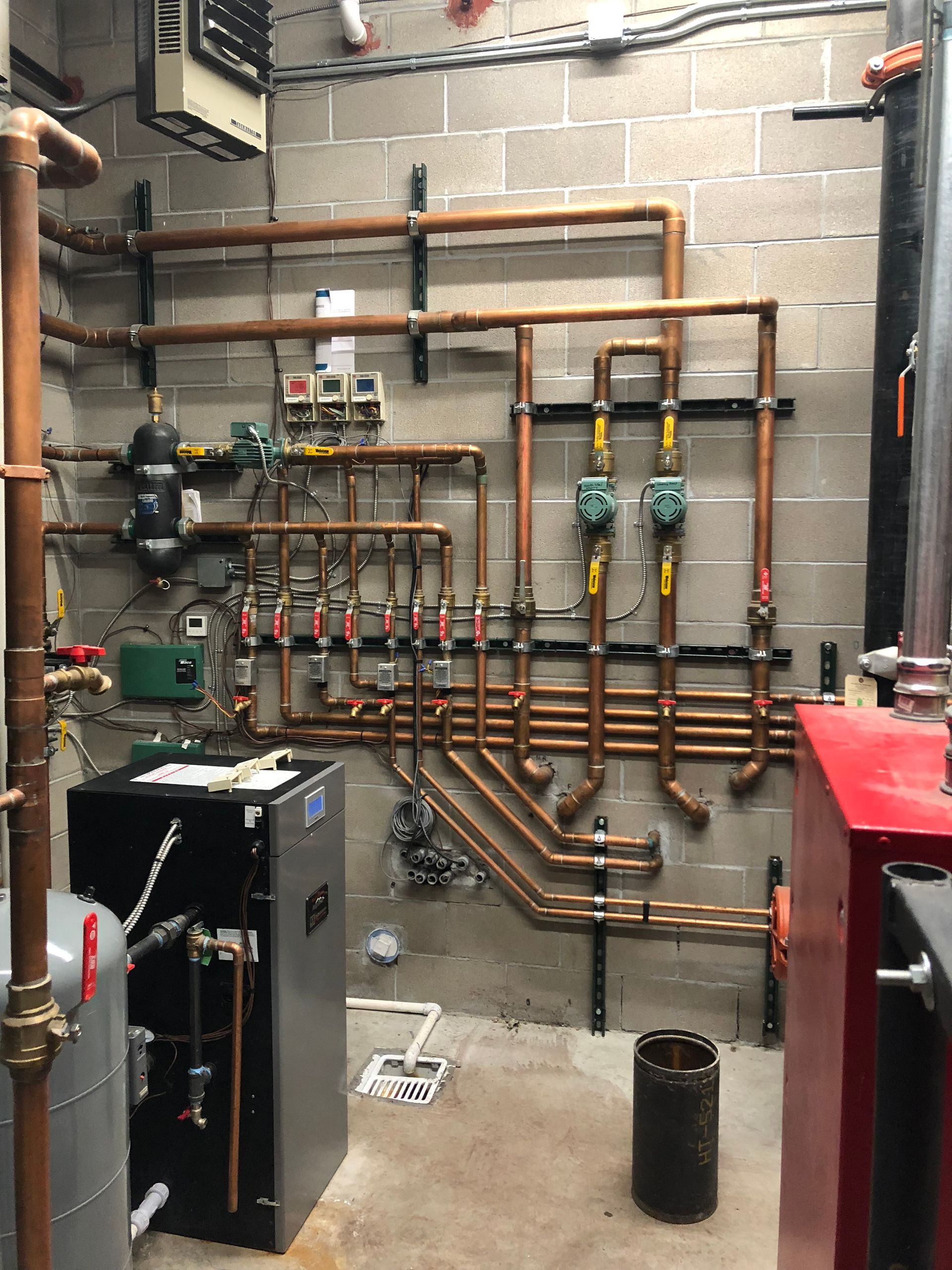 A room with a lot of pipes hanging on the wall