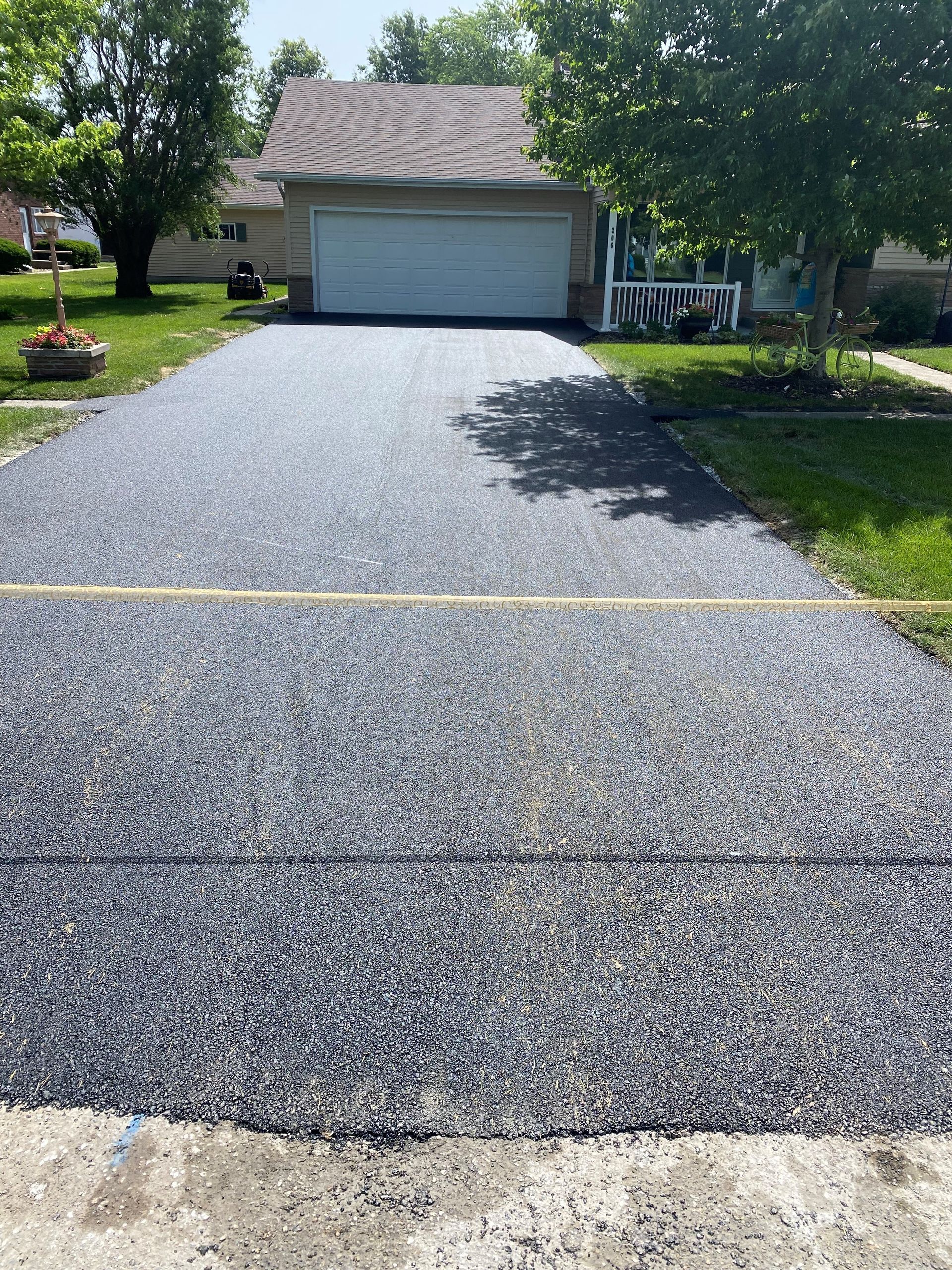 A truck is driving down a road with a machine on it.