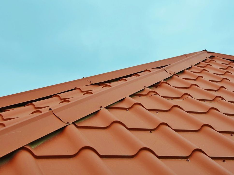Orange tiled roof against a blue sky.
