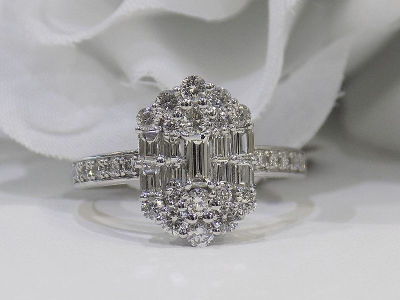Diamond ring with a cluster of stones on a white surface