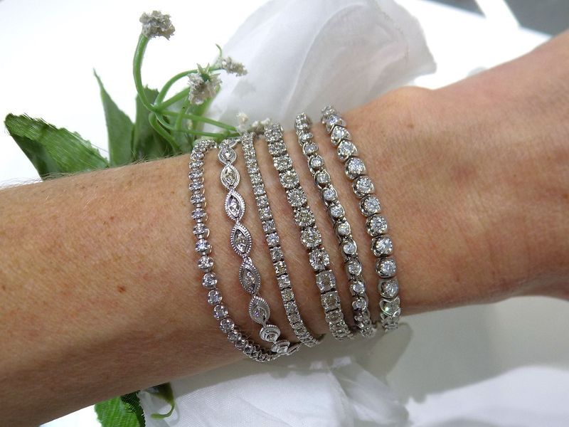 Woman's wrist adorned with multiple diamond bracelets