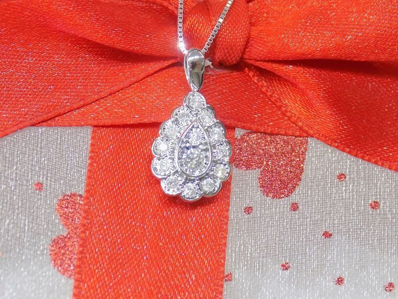 Diamond teardrop pendant necklace on a red ribbon