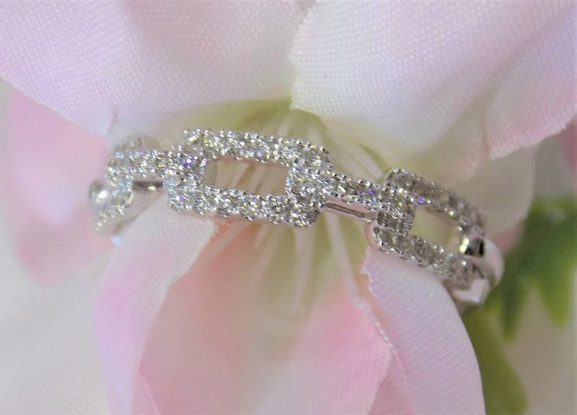 Diamond chain ring on pink flower petals