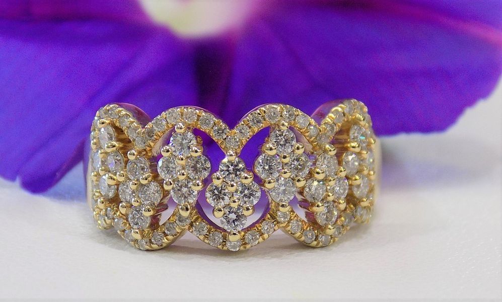 Gold diamond ring with three connected petal-like shapes