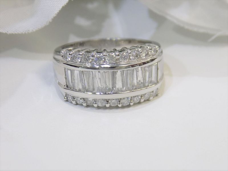 Diamond-studded ring with baguette-cut stones in a white setting