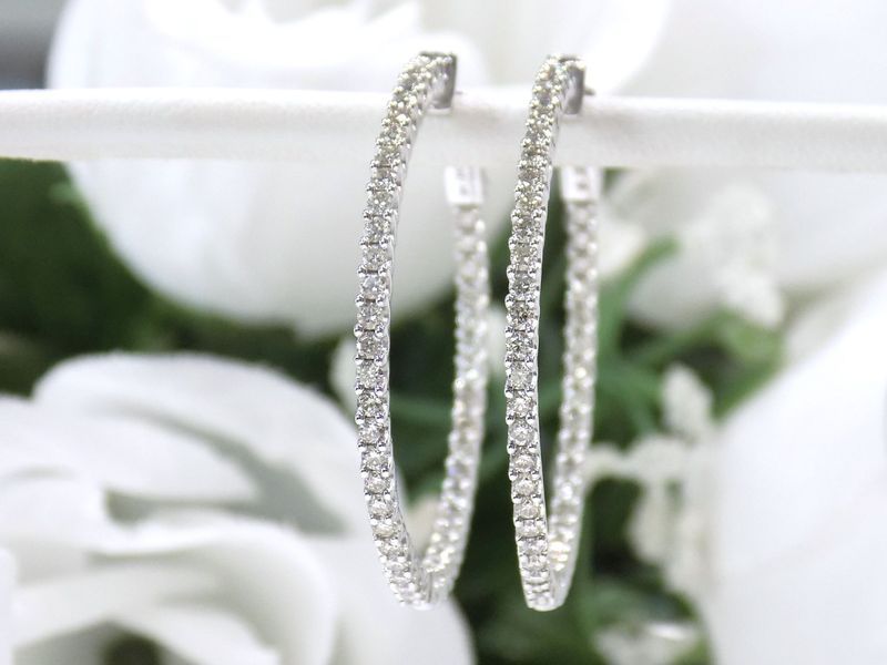 Diamond hoop earrings on white background