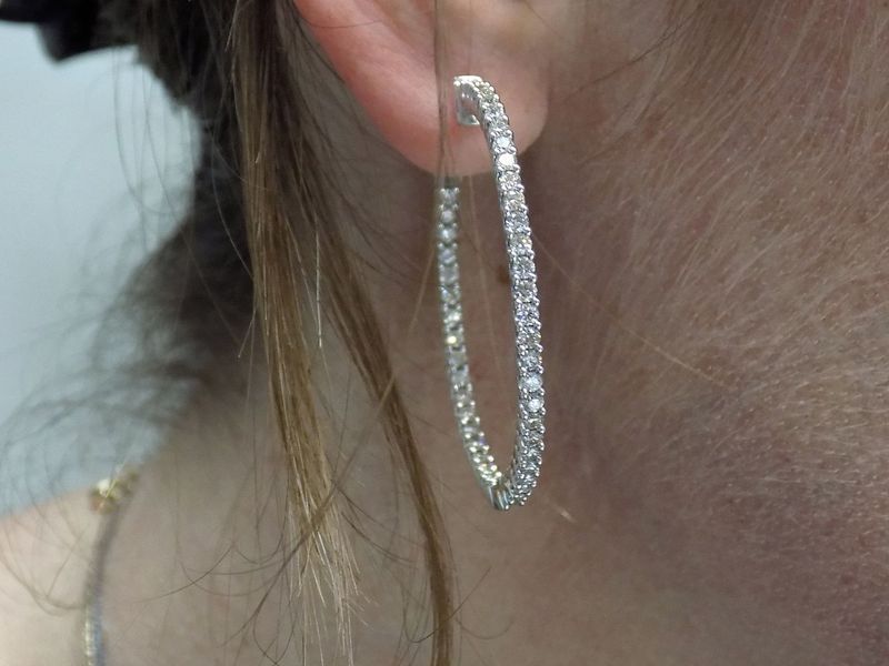 Woman wearing diamond hoop earrings