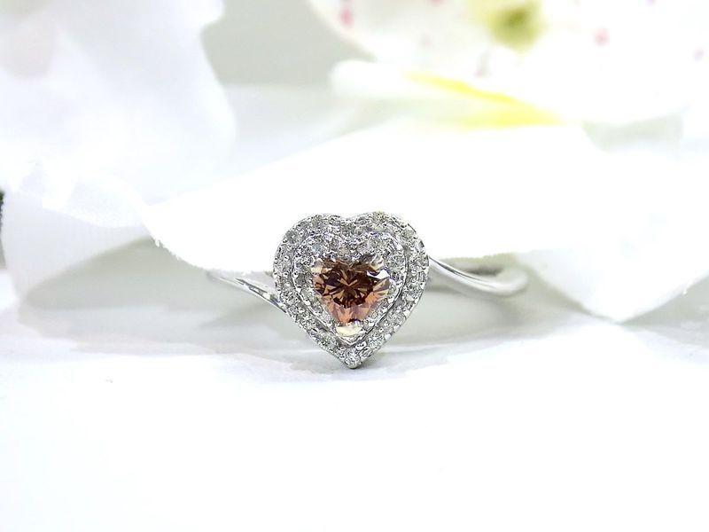 Heart-shaped diamond ring with a brown center stone