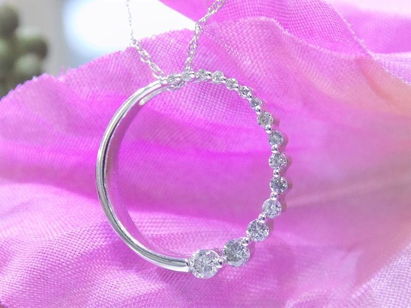 Silver necklace with diamonds on a pink flower