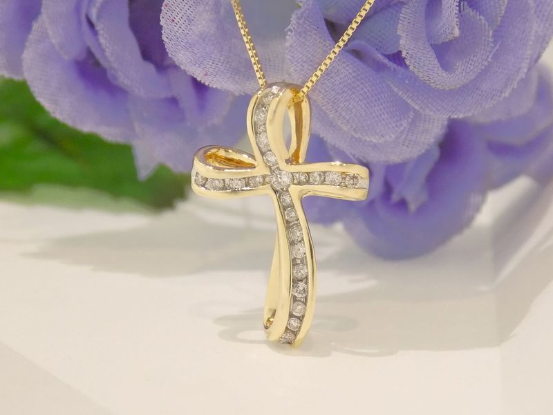 Gold cross pendant with diamonds on a gold chain