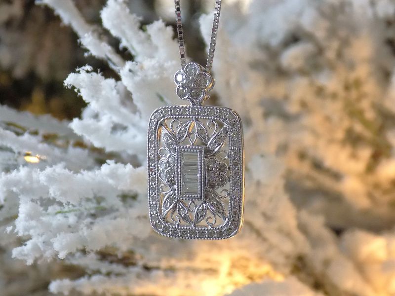 Diamond pendant necklace on a snowy branch