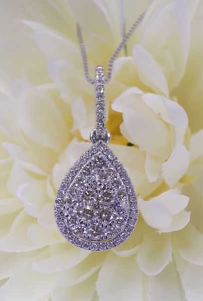Diamond pendant necklace on a white flower
