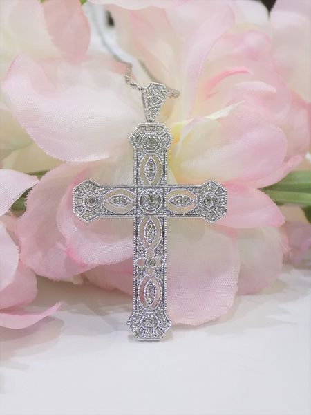 Diamond-studded cross pendant on a silver chain