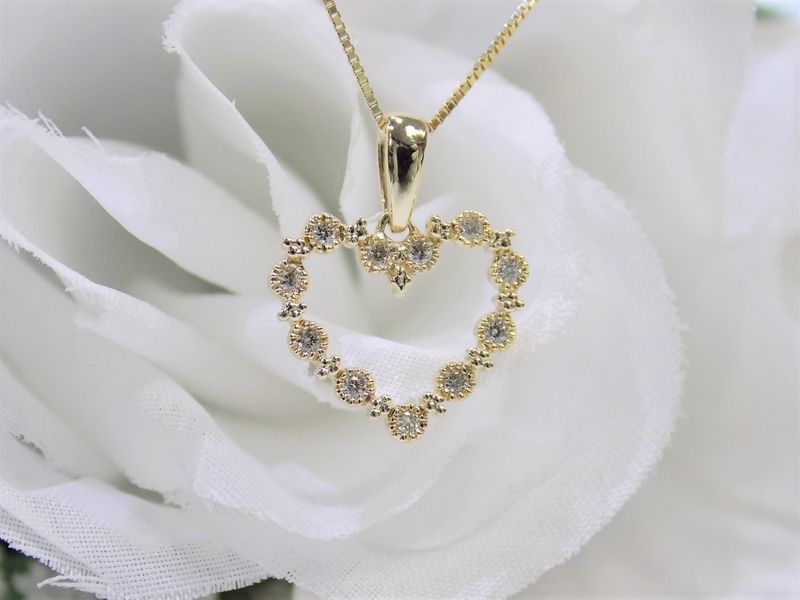 Gold heart pendant necklace with diamonds.