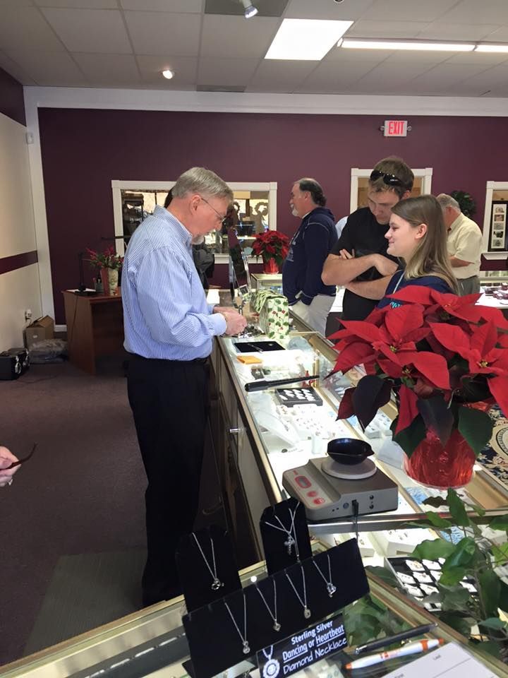 People browsing jewelry at a shop counter