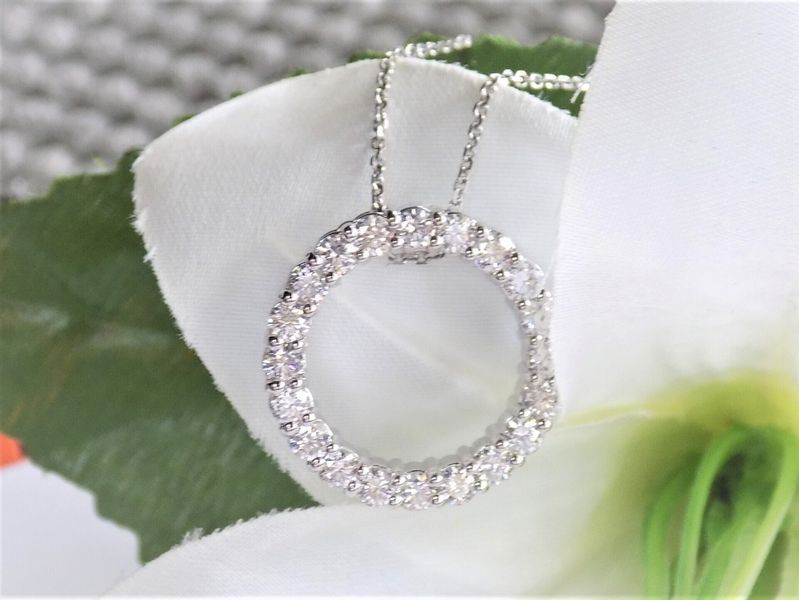 Diamond circle pendant on a white flower