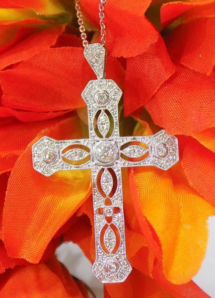 Diamond-studded cross pendant on a delicate chain