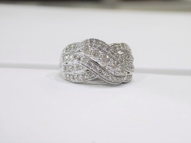 Diamond-studded white gold ring in a knot design