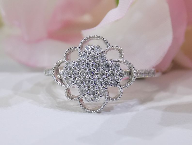 Silver ring with a diamond-studded clover-shaped design