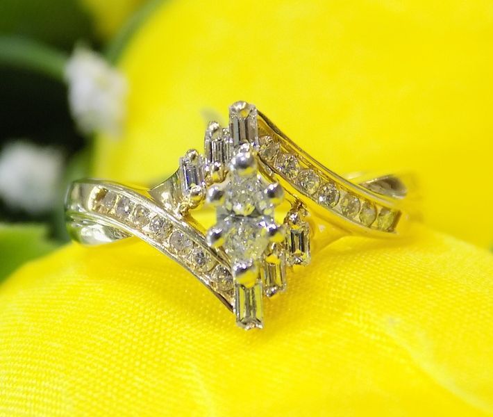 Gold ring with a marquise-cut diamond center