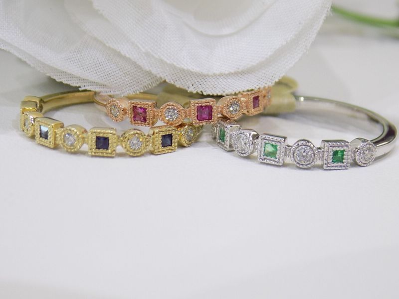 Three gemstone eternity rings in gold