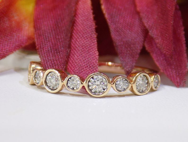 Gold ring with bezel-set diamonds