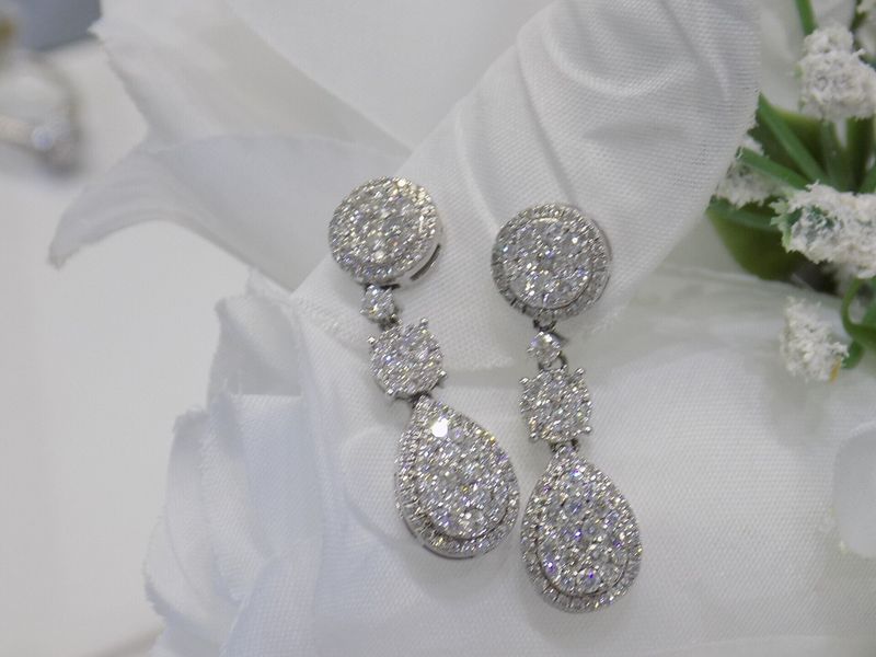 Diamond dangle earrings with three tiers