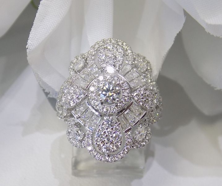 Diamond-studded ring on a clear stand