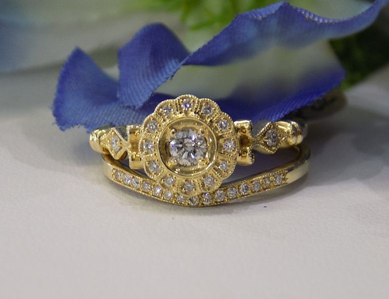 Gold ring set with a diamond halo engagement ring