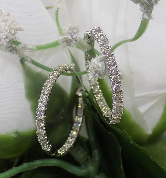 Diamond hoop earrings on white flowers