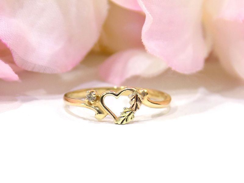 Gold ring with heart-shaped center and leaf details