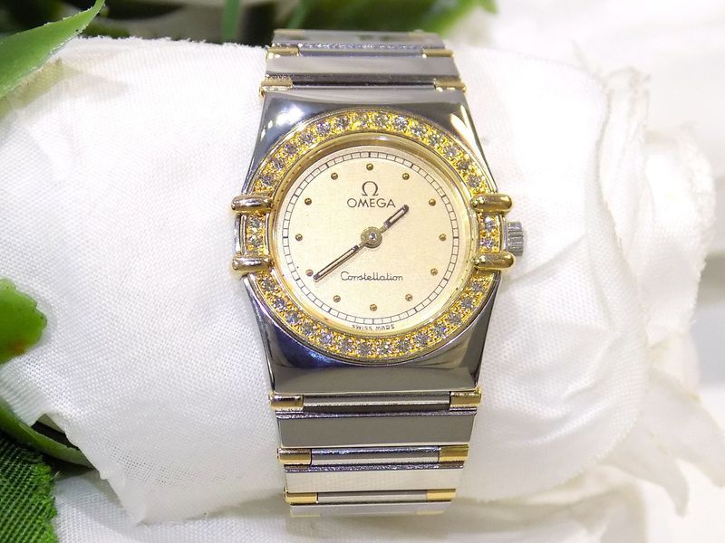 Omega constellation watch with a gold bezel set with jewels,