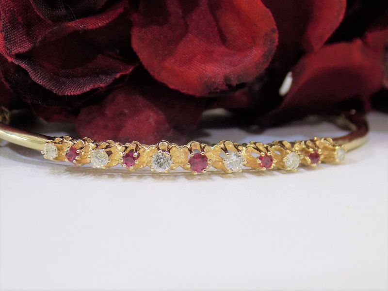 Gold bangle bracelet with alternating rubies and diamonds