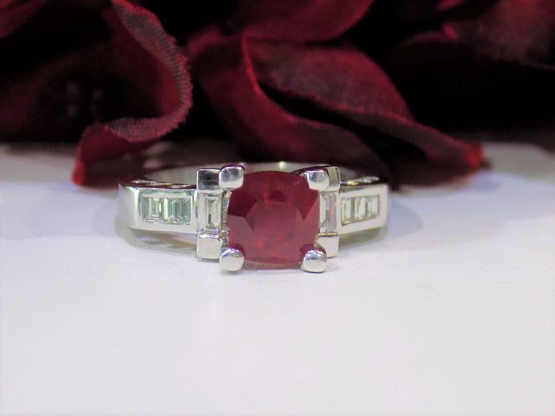 Ruby and diamond ring on a white surface