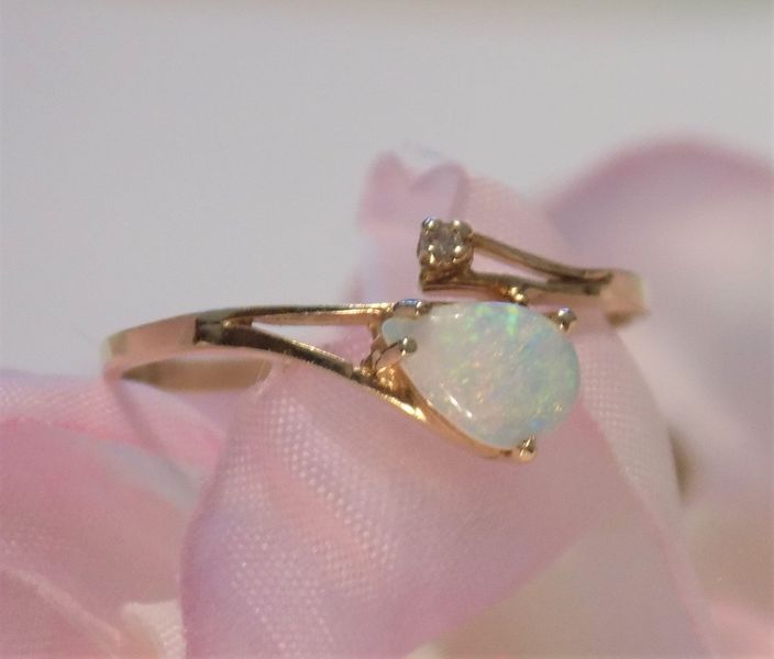 Gold ring with pear-shaped opal and small diamond 