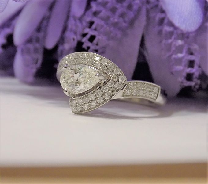Diamond ring with a pear-shaped center stone