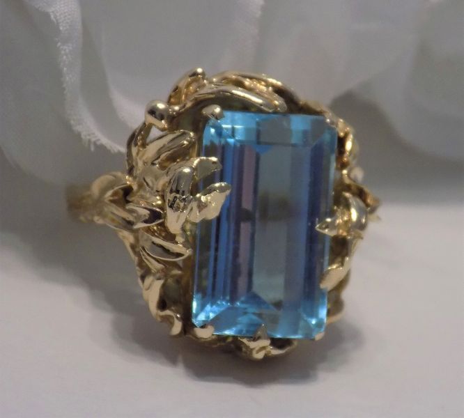 Gold ring with a large rectangular blue gemstone