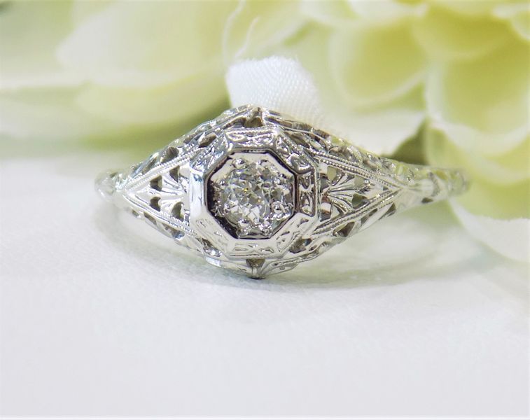 Diamond engagement ring with intricate filigree detailing