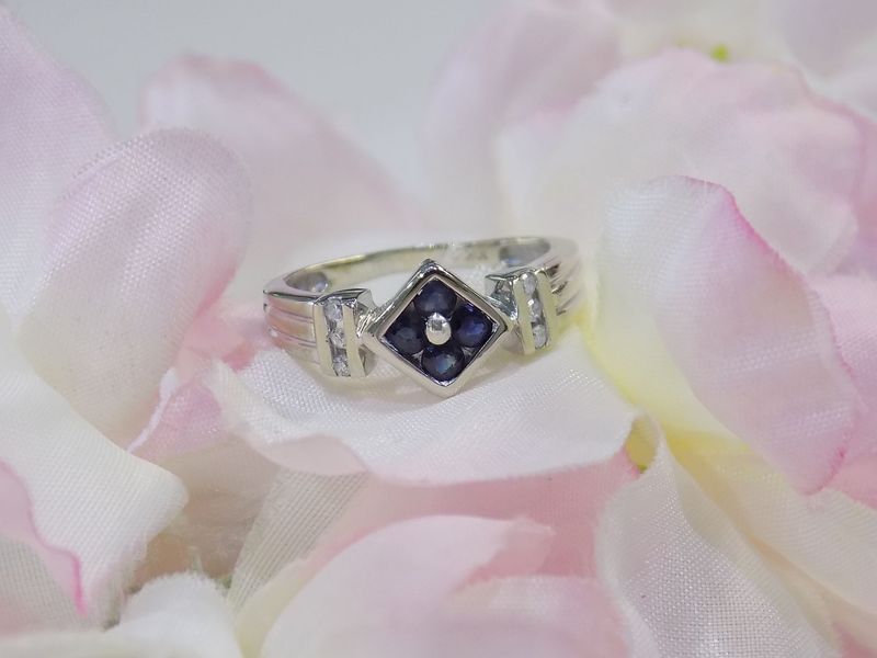 Silver ring with a square of blue gemstones