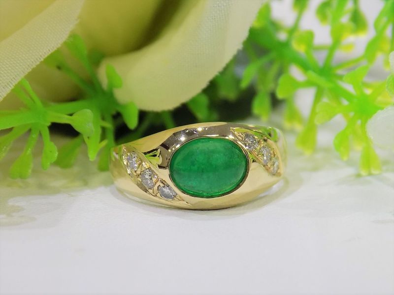 Gold ring with a large oval green gemstone