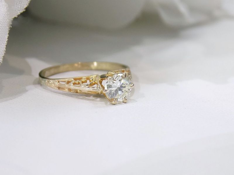Gold engagement ring with a round diamond