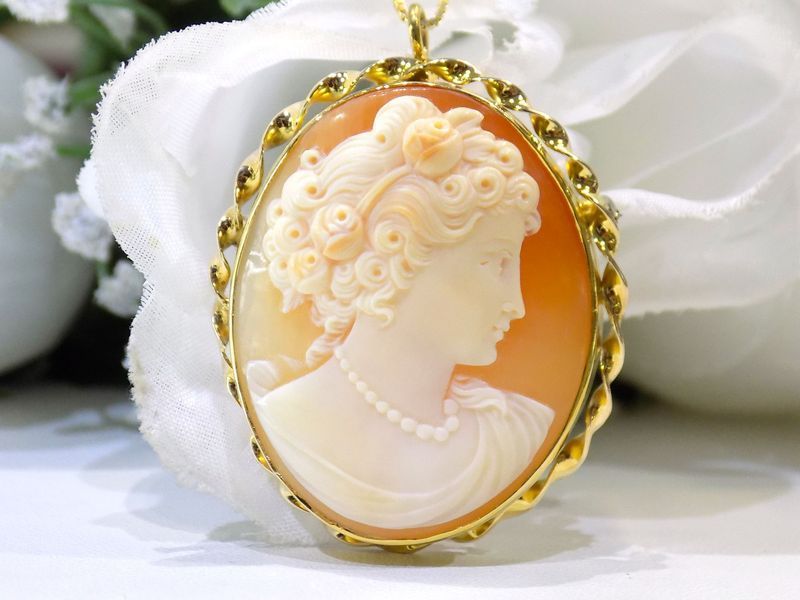Gold cameo pendant with a woman's profile