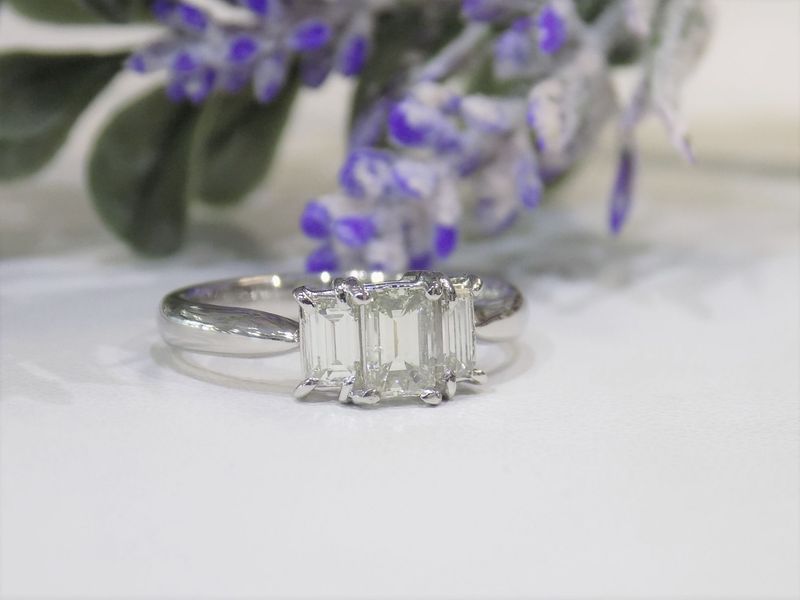 Diamond ring with three emerald-cut stones