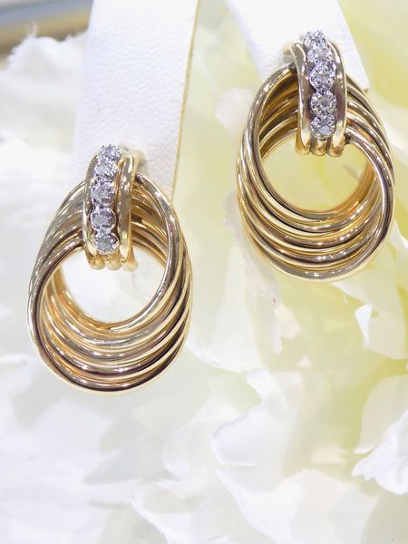 Gold earrings with diamond accents, oval looped design